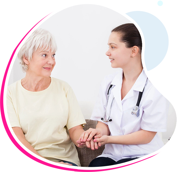 A nurse and an older woman holding hands.